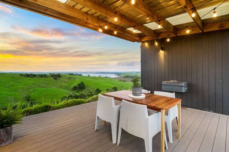 The bach at 107A Hall Road, Tinopai, Kaipara, goes to auction on November 30. Photo / Supplied