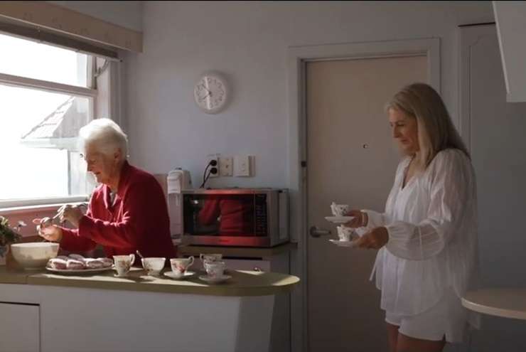 Listing agent Kay Ganley's mum Judy and her granddaughter Georgia appear in the marketing video for the 1950s beachfront bach on Oceanbeach Road, in Mount Maunganui. Photo / Supplied