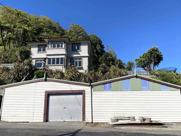 A three-bedroom home partially built from an old train carriage is on the market at 4 Driver Street, in Long Beach, Dunedin. Photo / Supplied