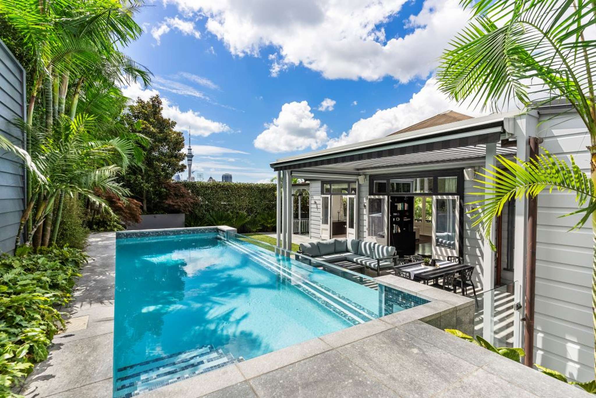 Auckland villa’s glass wall pool and wine cellar are star attractions