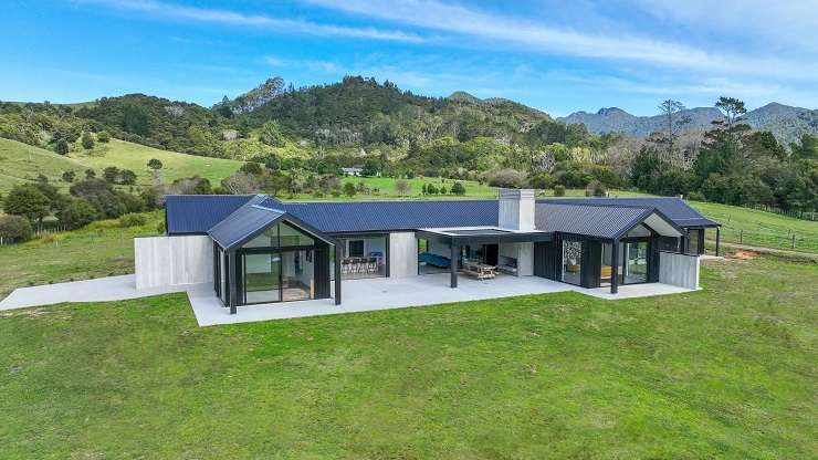 A four-bedroom, four-bathroom beachfront property at 135 Captain Cook Road, in Cooks Beach, has just been listed for sale this week and is among the unusually large number of bigger homes for sale in the beach town. Photo / Supplied