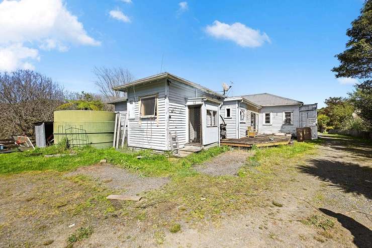 A stripped-out villa and three other homes on a 2.09ha lifestyle section in Whatawhata sold at auction for $929,000. Photo / Supplied