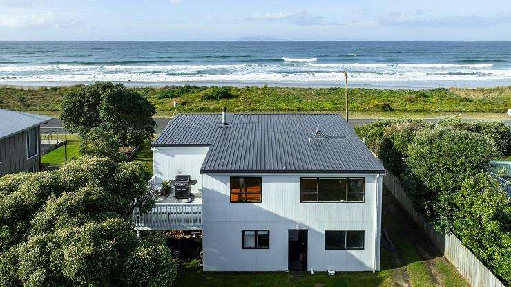 The vintage four-bedroom bach at 112 Broadway Road, at Waihi Beach, goes to auction next month. Photo / Supplied