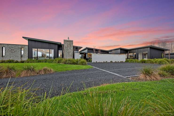 black and white house with clipped garden hedges 23 Tatham Road, Ti Point