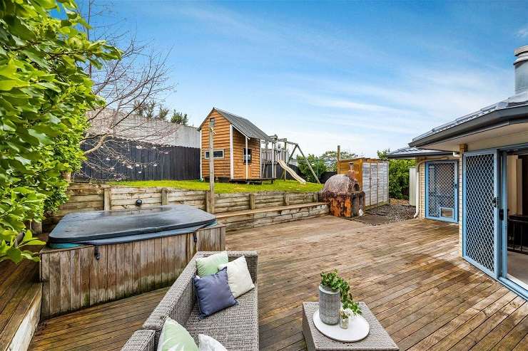 brick and tile house with blue garage door and sunset  14 Ginders Drive Massey