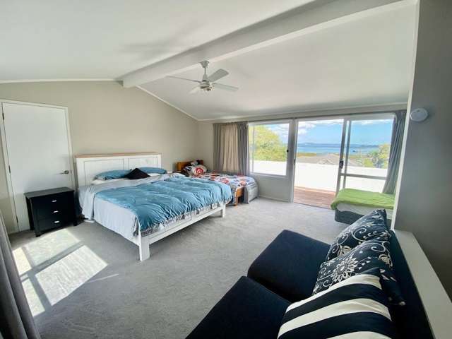 A top-floor master bedroom with ocean views