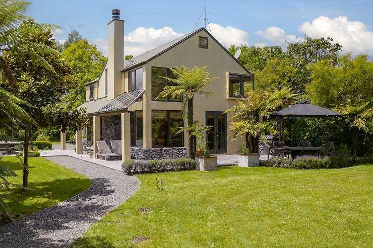 The three-bedroom, two-bathroom home on Humu Street, in Tokaanu, has direct access to a stream and its own geothermal hot tub. Photo / Supplied