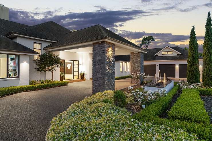 black and white house with clipped garden hedges 23 Tatham Road, Ti Point