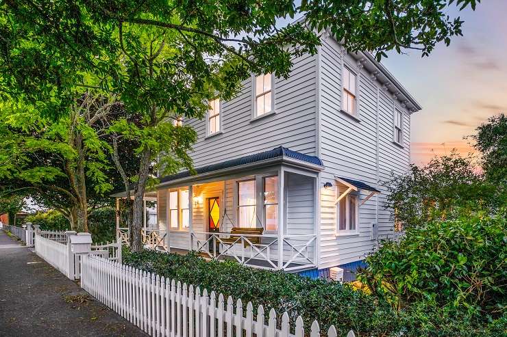 a white bungalow with hedge and lawn on 19 Platina Street, Remuera, Auckland