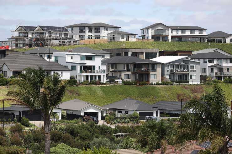 green field and white house with garage 86 Matija Place, Red Beach, Rodney, Auckland