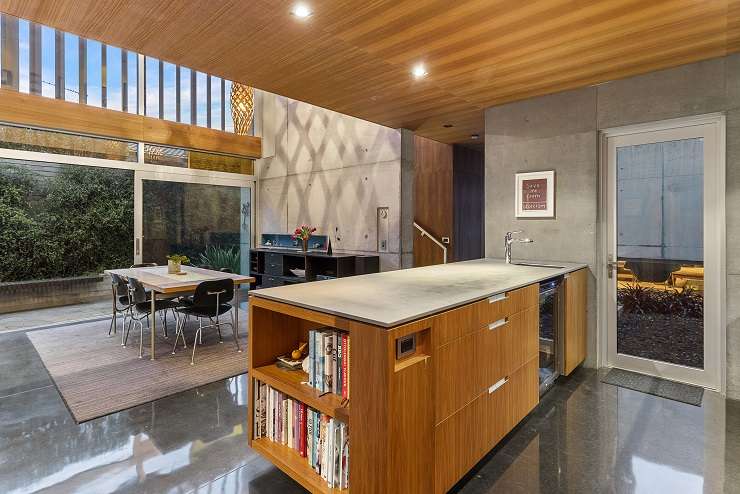 A three-bedroom house for sale on Regina Street, in Coxs Bay. The home, by architect Steven Lloyd, features concrete, glass and steel cantilevered over the carport. Photo / Supplied