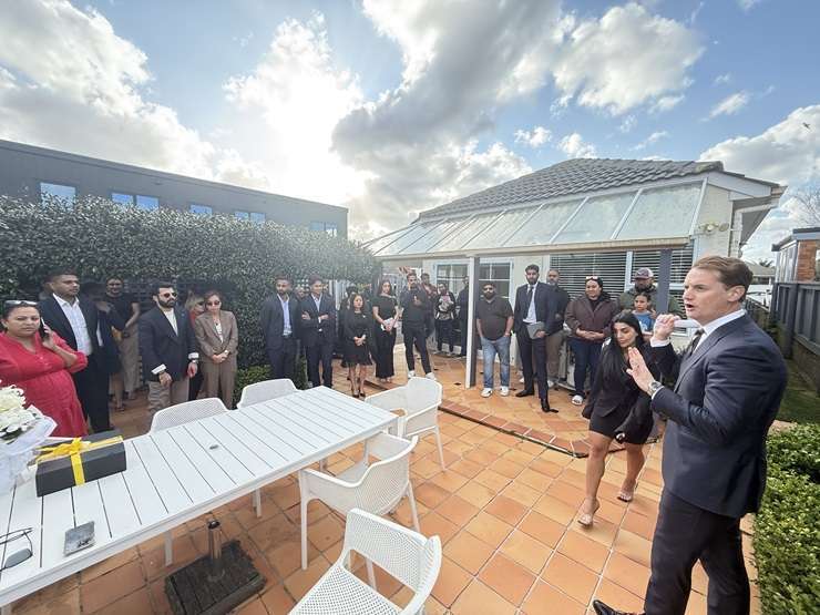 Mike King hugs his listing agent Fatima Ali after his Papatoetoe property sold. Photo / Supplied