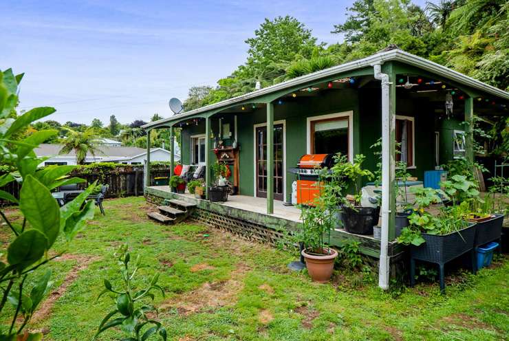 A three-bedroom home partially built from an old train carriage is on the market at 4 Driver Street, in Long Beach, Dunedin. Photo / Supplied