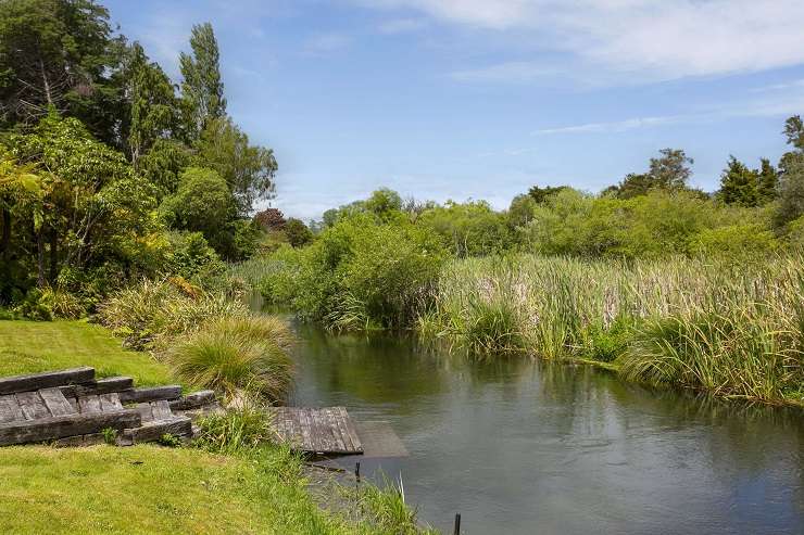 The three-bedroom, two-bathroom home on Humu Street, in Tokaanu, has direct access to a stream and its own geothermal hot tub. Photo / Supplied