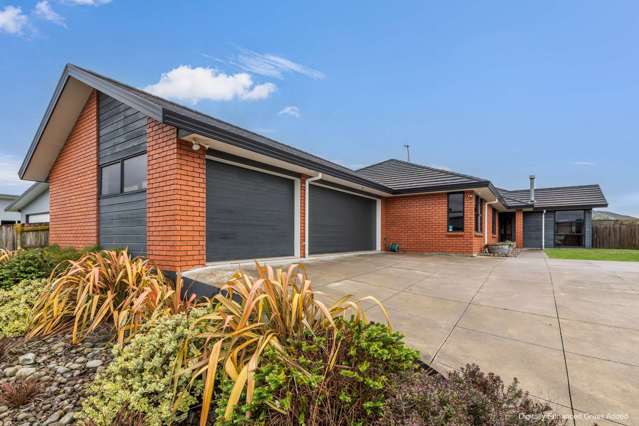 Stylish, Sleek, Triple car garage and Brick!