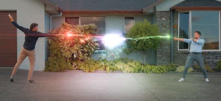 Barfoot & Thompson agent Jason Tabrum hurls lightning bolts and fancy spells at his colleague Luke Jupp in front of a Franklin lifestyle property they were selling. Photo / Supplied