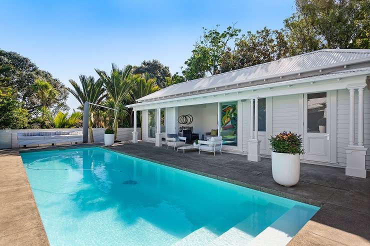 white villa with green lawn in front  60 Marine Parade, Herne Bay, Auckland