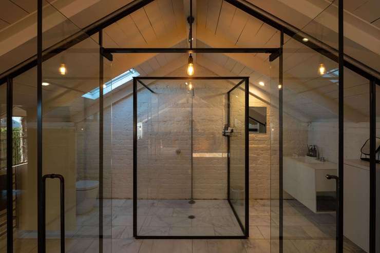 1 Albany Road, in Auckland's Herne Bay, is a modern concrete house that shares its grounds with a heritage brick stable. It is back on the market after three years. Photo / Supplied