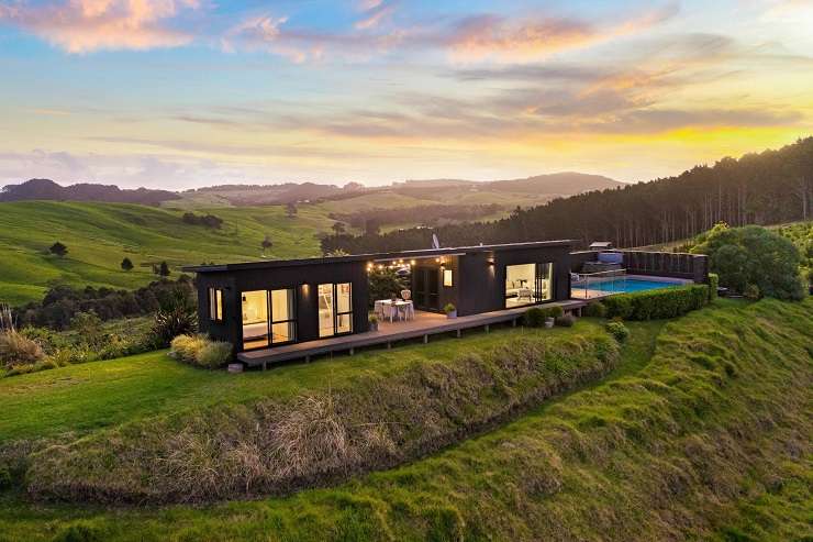 The bach at 107A Hall Road, Tinopai, Kaipara, goes to auction on November 30. Photo / Supplied