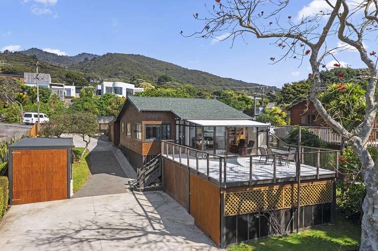 The two-bedroom Wainui Road home, which is one of 10 properties in sought-after Whale Bay, sold for $3m plus. Photo / Supplied