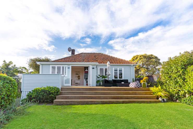 pale green villa with white trim and lights on 74 Vermont Street Grey Lynn Auckland