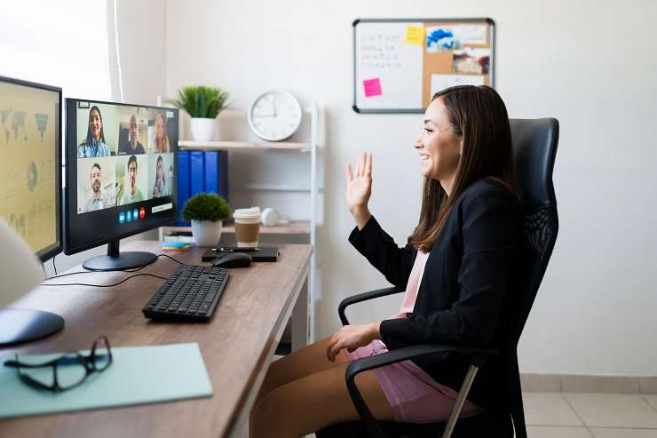 woman in home office with head in her hands