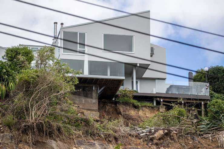 The effects of the recent flooding and land slips on properties lining Shore Road, in Remuera, and above it, on Arney Road. Photo / Hayden Woodward