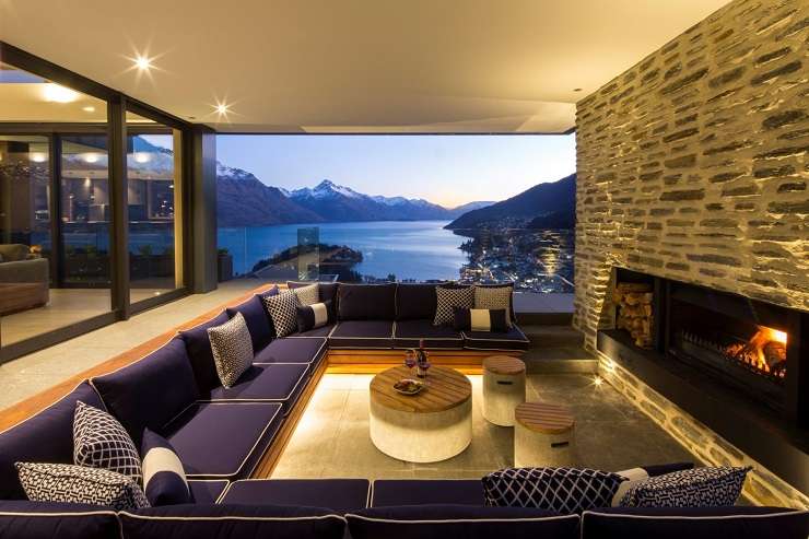 stone and glass house with pine trees behind  10 Pinnacle Place, QUeenstown