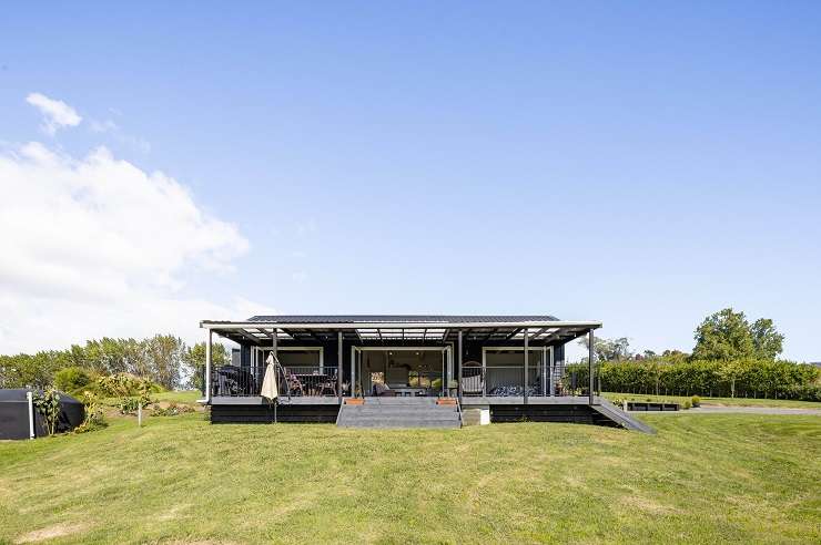 The five-bedroom, three-bathroom home on Ranby Road, in Ohaupo, was built using 12 steel shipping containers. Photo / Supplied